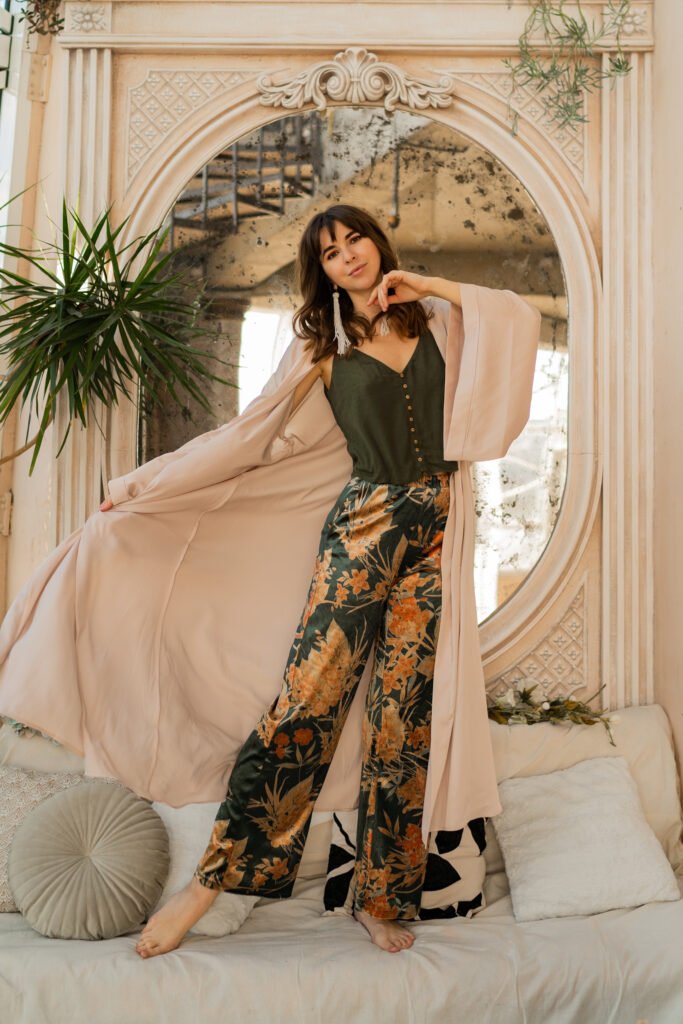 Why Us? beautiful woman in elegant wome wear posing in stylish bohemian interior.